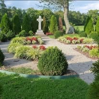 Salem Presbyterian Church prayer garden with statue, flowers, and manicured greenery
